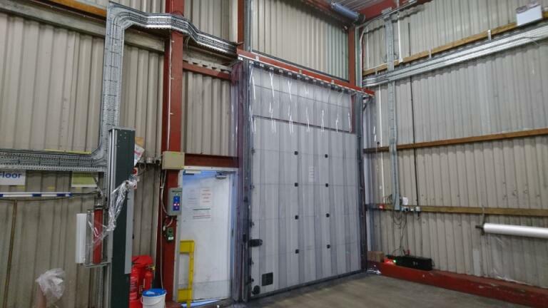 PVC strip curtains installed on a white warehouse door