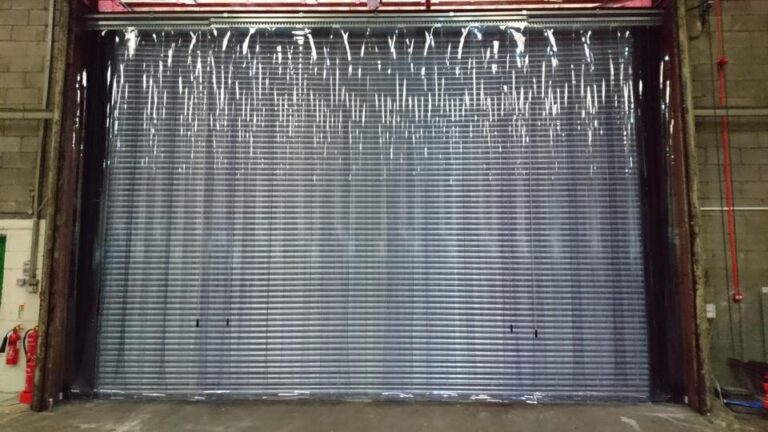 Essentail Trading PVC Strip Curtains installed on a metal warehouse door
